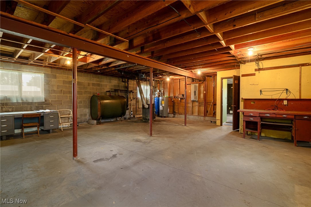 6747 Giddings Road Rootstown, OH 44272 - Photo 24 of 39 Basement with oil tank, boiler, hot water tank, work shop area and plenty of windows