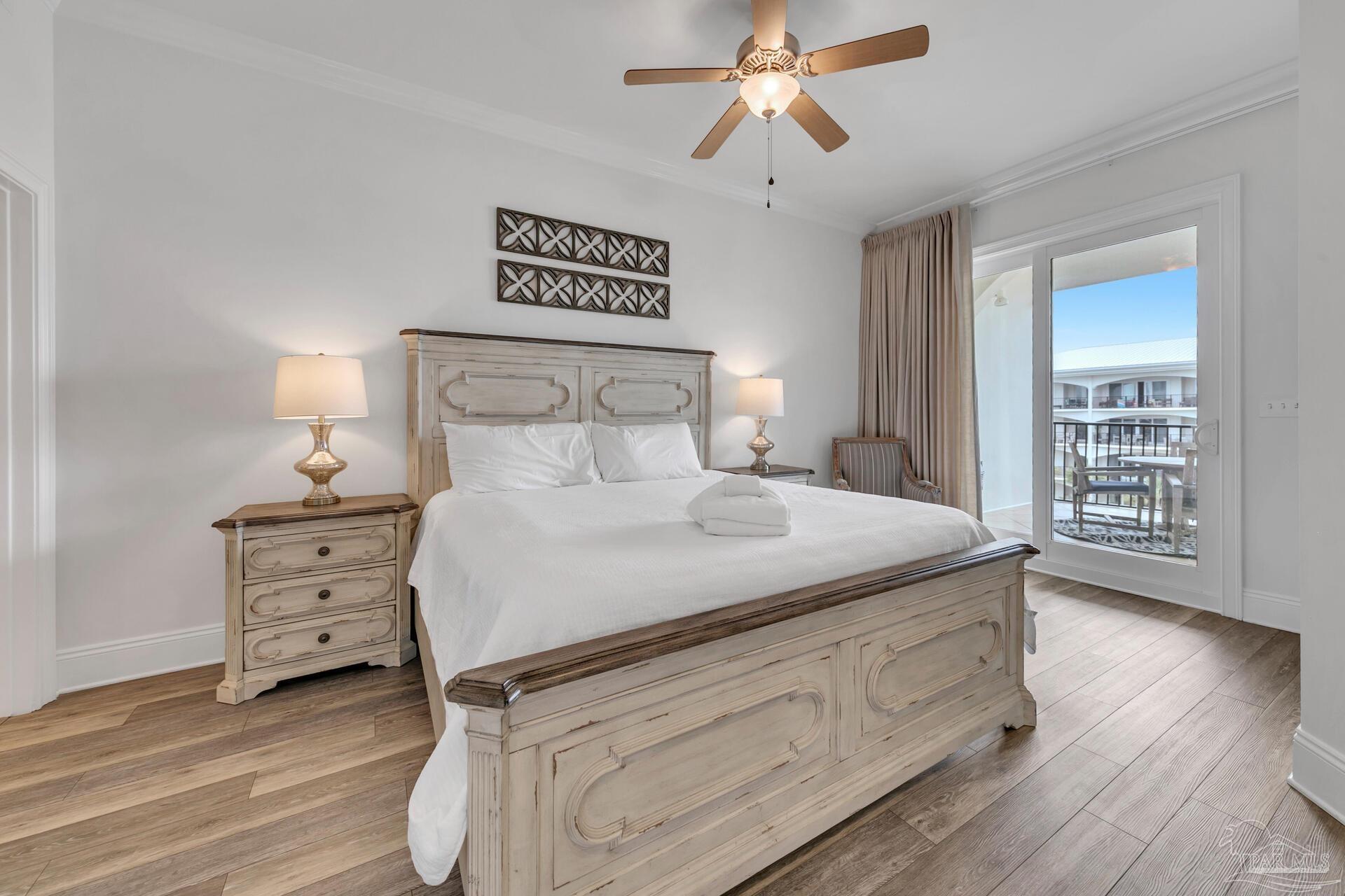 2421 West County Highway 30A, Unit G405 Santa Rosa Beach, FL 32459 - Photo 13 of 35 a bedroom with a bed and a chandelier