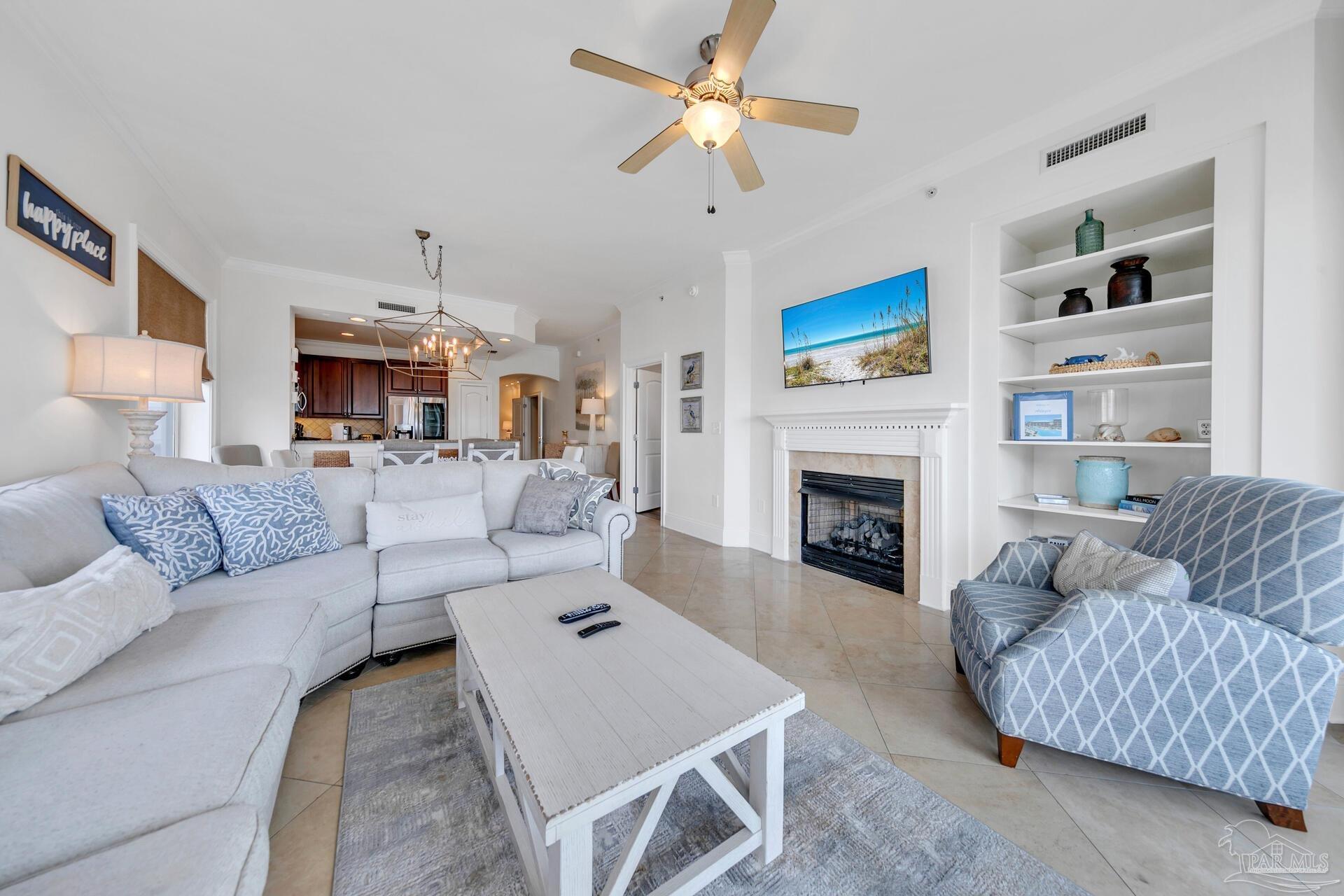 2421 West County Highway 30A, Unit G405 Santa Rosa Beach, FL 32459 - Photo 14 of 35 a living room with furniture a fireplace and a flat screen tv