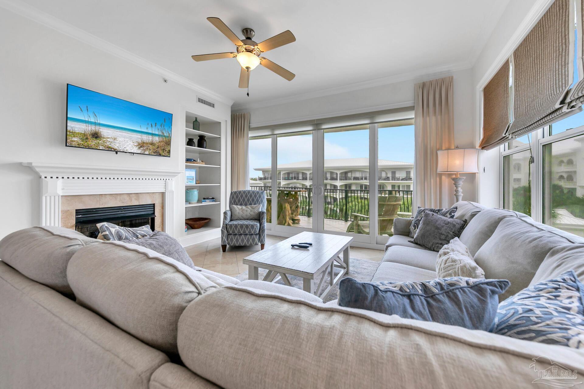 2421 West County Highway 30A, Unit G405 Santa Rosa Beach, FL 32459 - Photo 17 of 35 a living room with furniture large window and a fireplace