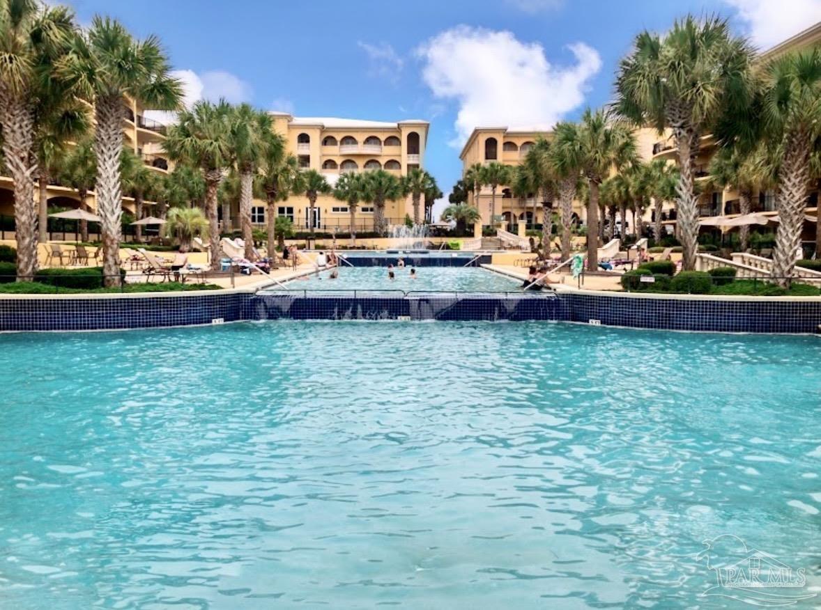 2421 West County Highway 30A, Unit G405 Santa Rosa Beach, FL 32459 - Photo 2 of 35 a view of a swimming pool with an outdoor space and seating area