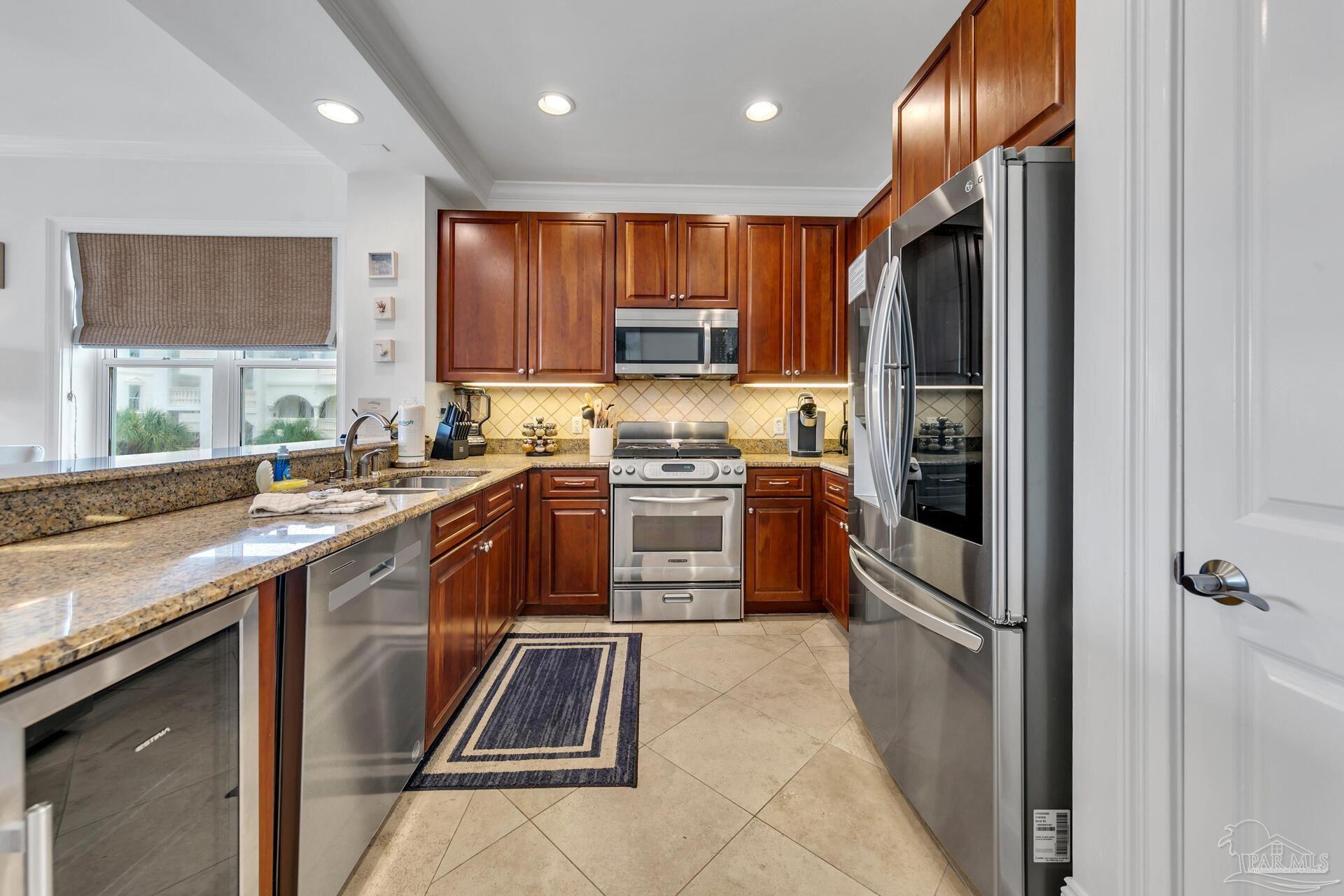 2421 West County Highway 30A, Unit G405 Santa Rosa Beach, FL 32459 - Photo 22 of 35 a kitchen with stainless steel appliances granite countertop a refrigerator and a sink