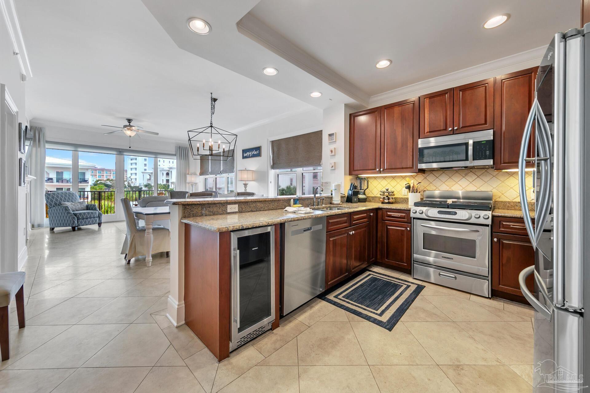 2421 West County Highway 30A, Unit G405 Santa Rosa Beach, FL 32459 - Photo 23 of 35 a kitchen with a stove sink and a refrigerator