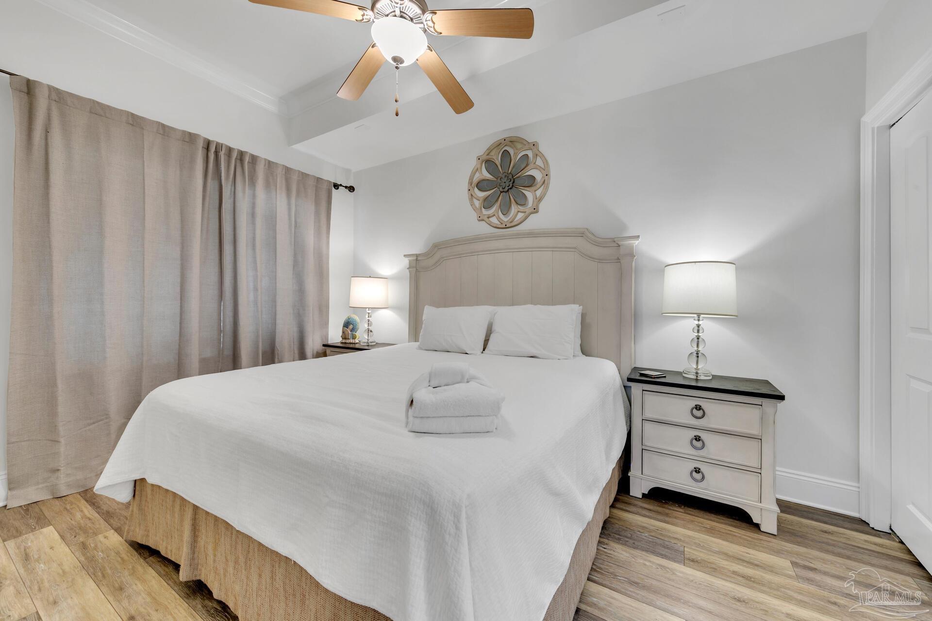 2421 West County Highway 30A, Unit G405 Santa Rosa Beach, FL 32459 - Photo 31 of 35 a bedroom with a bed and a chandelier