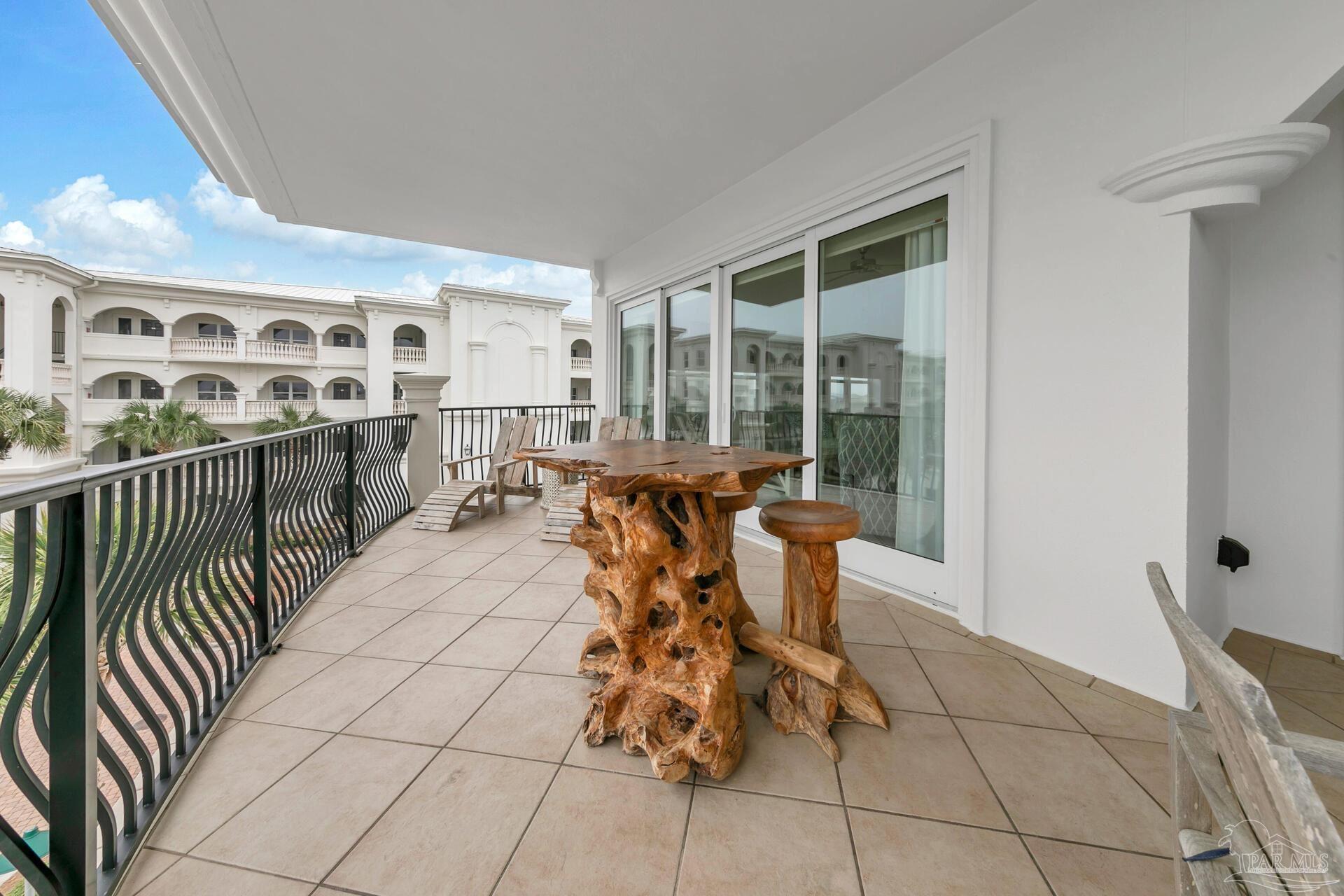 2421 West County Highway 30A, Unit G405 Santa Rosa Beach, FL 32459 - Photo 5 of 35 a dining room with furniture a floor to ceiling window and potted plants