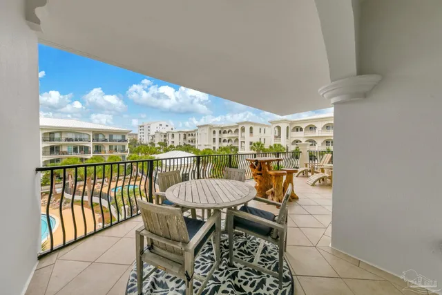 a view of a chairs and table in patio