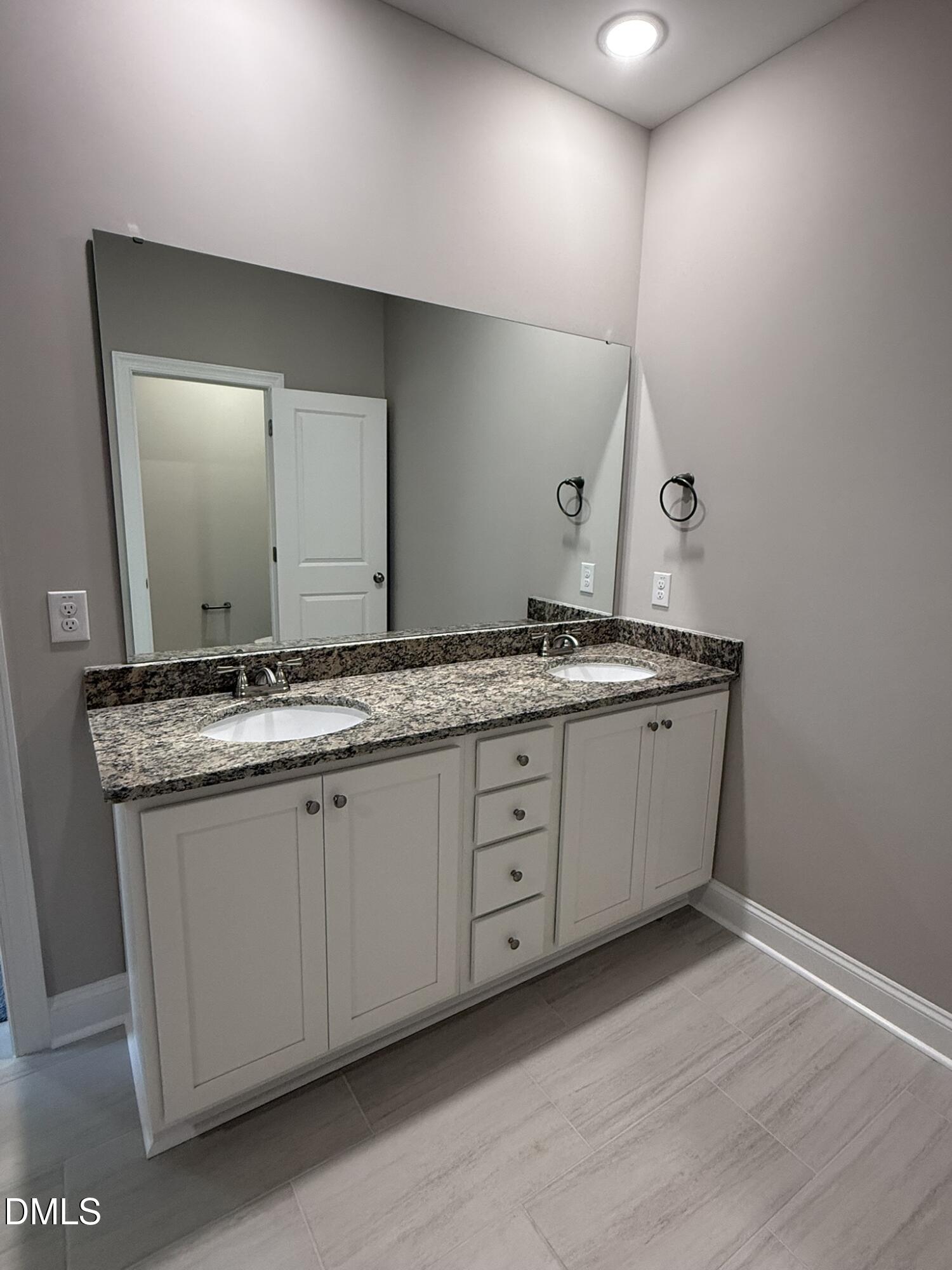 70 Hot Spgs Way Benson, NC 27504 - Photo 14 of 29 a bathroom with a granite countertop sink and a mirror
