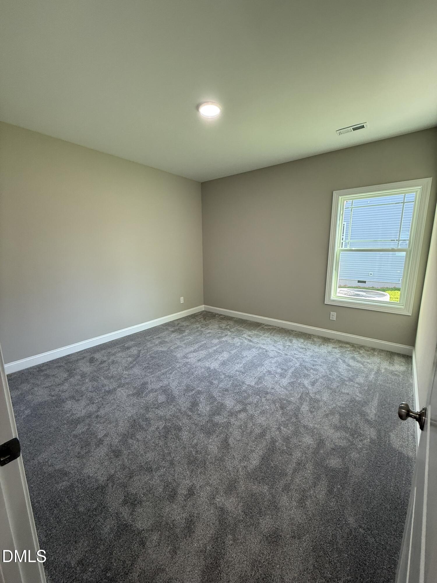 70 Hot Spgs Way Benson, NC 27504 - Photo 19 of 29 an empty room with a window
