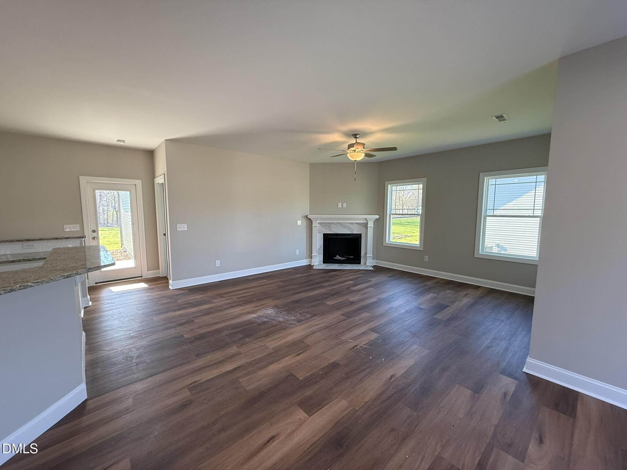 70 Hot Spgs Way Benson, NC 27504 - Photo 5 of 29 a view of empty room with kitchen and fireplace