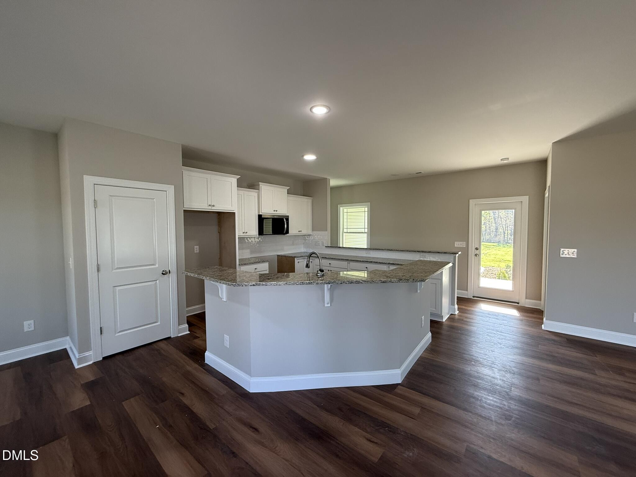 70 Hot Spgs Way Benson, NC 27504 - Photo 6 of 29 a view of kitchen with stainless steel appliances refrigerator stove microwave and cabinets