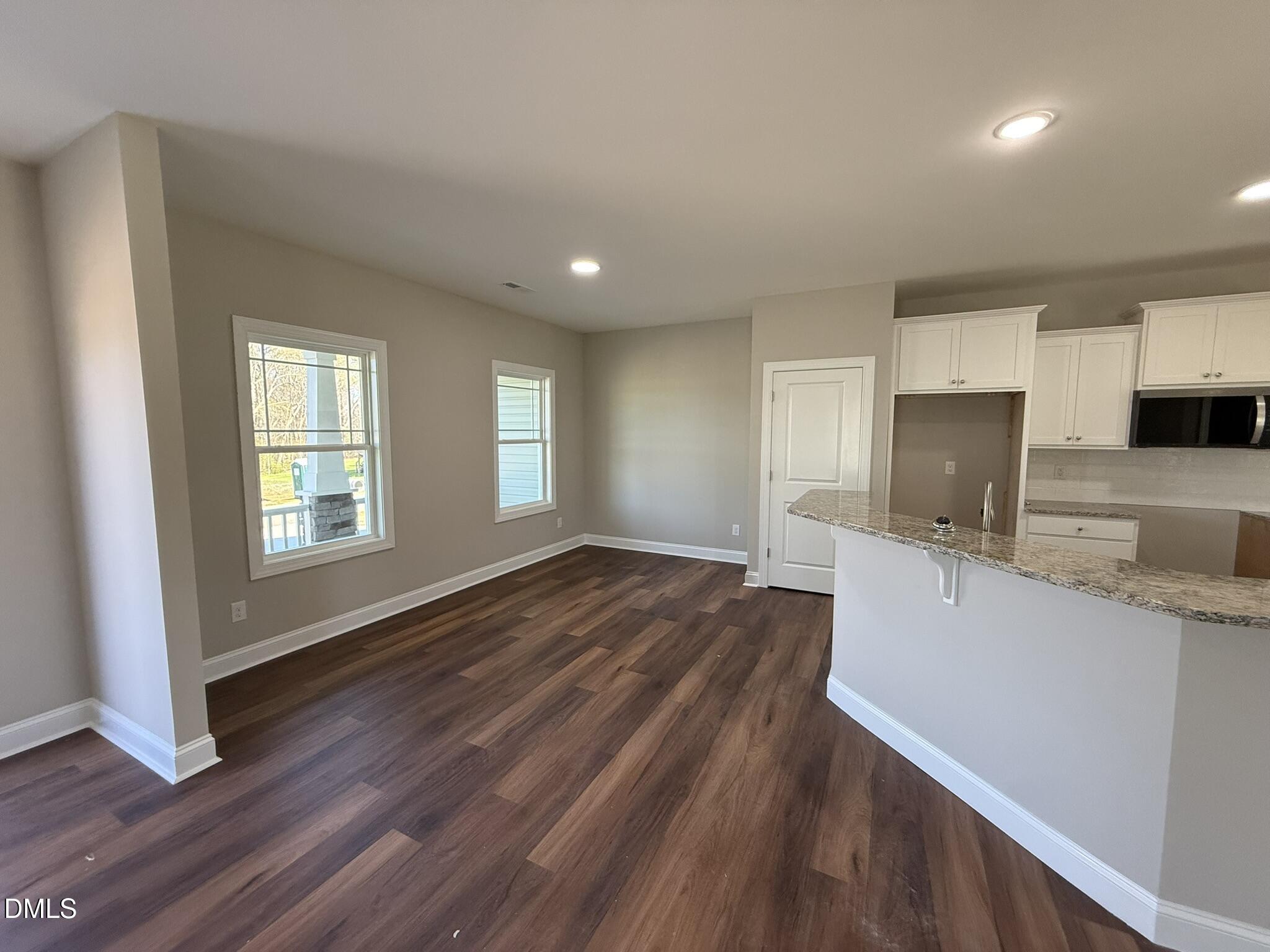 70 Hot Spgs Way Benson, NC 27504 - Photo 9 of 29 a view of a kitchen with a sink wooden cabinets and entryway