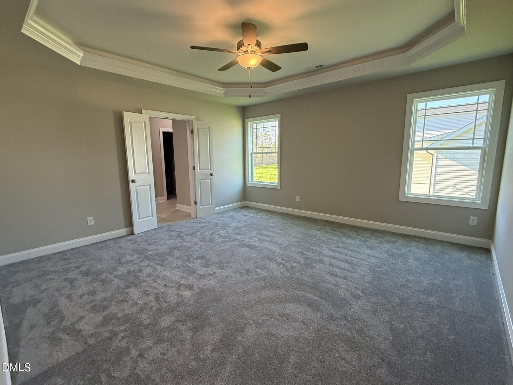 70 Hot Spgs Way Benson, NC 27504 - Photo 10 of 29 an empty room with windows and fan