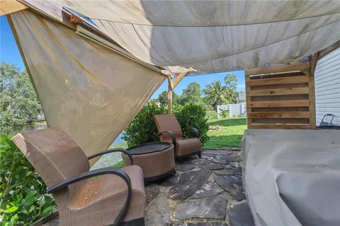 a view of a patio with couple of chairs and a potted plants