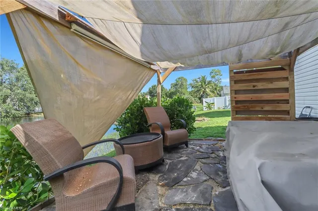 a view of a patio with couple of chairs and a potted plants