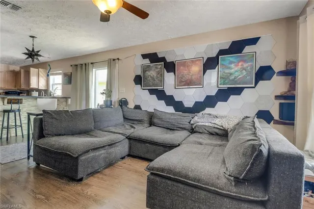 a living room with furniture and a chandelier