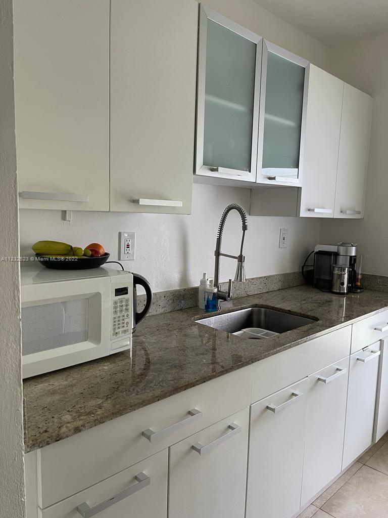 100 Sunrise Drive, Unit 25 Key Biscayne, FL 33149 - Photo 11 of 21 a kitchen with appliances a sink and cabinets