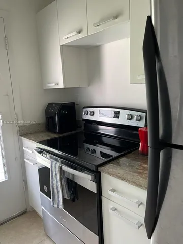 a stove top oven sitting inside of a kitchen