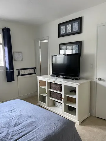 a view of a livingroom with furniture and a flat screen tv