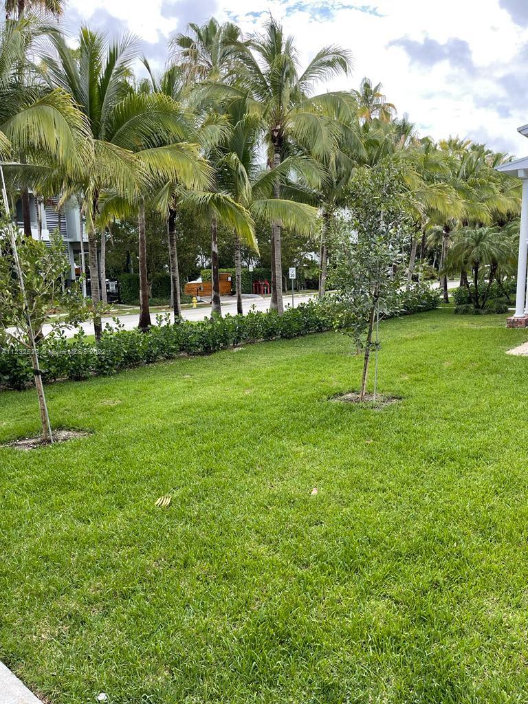 100 Sunrise Drive, Unit 25 Key Biscayne, FL 33149 - Photo 2 of 21 a view of a house with a backyard
