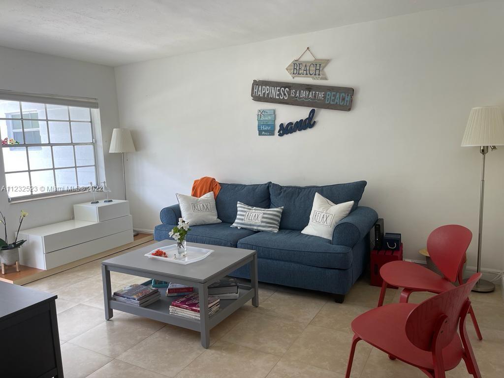 100 Sunrise Drive, Unit 25 Key Biscayne, FL 33149 - Photo 5 of 21 a living room with furniture a rug and a window