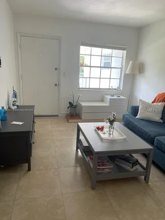 a living room with furniture and window