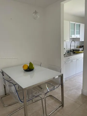 a kitchen with a table and chairs