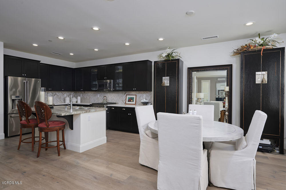 372 Calistoga Road Camarillo, CA 93010 - Photo 5 of 36 a large kitchen with kitchen island a sink a counter and chairs