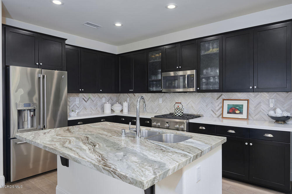 372 Calistoga Road Camarillo, CA 93010 - Photo 6 of 36 a kitchen with stainless steel appliances granite countertop a sink a stove a refrigerator and cabinets