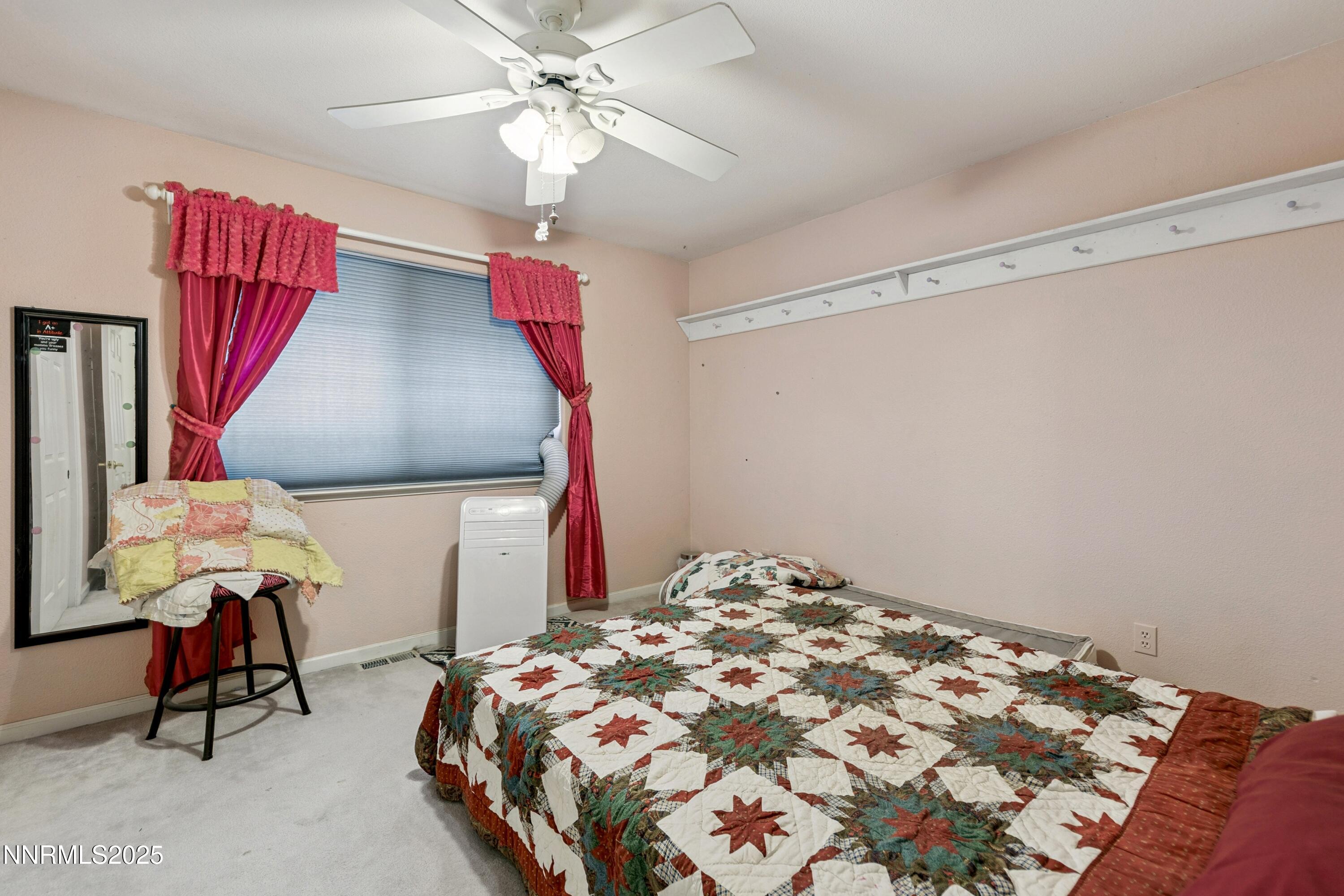 955 Carol Way Fernley, NV 89408 - Photo 16 of 42 a bedroom with a bed and a chandelier