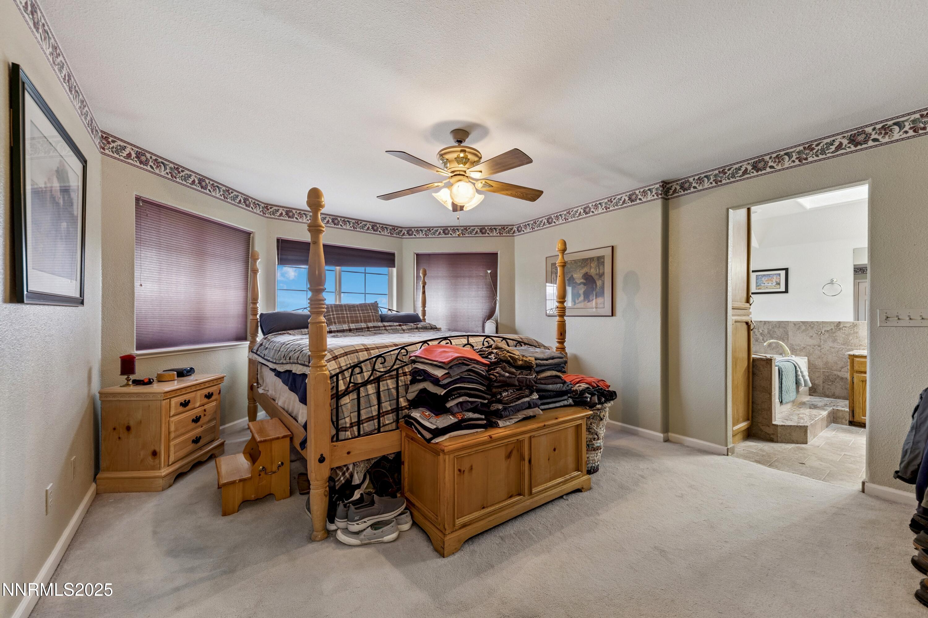 955 Carol Way Fernley, NV 89408 - Photo 17 of 42 a bed room with a bed and a chandelier