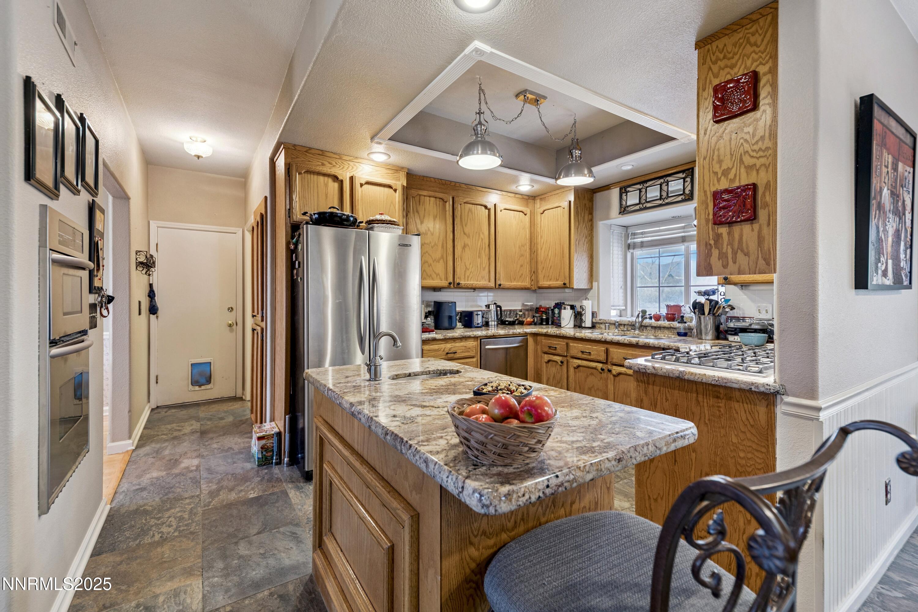 955 Carol Way Fernley, NV 89408 - Photo 26 of 42 a kitchen with stainless steel appliances granite countertop a sink refrigerator and cabinets