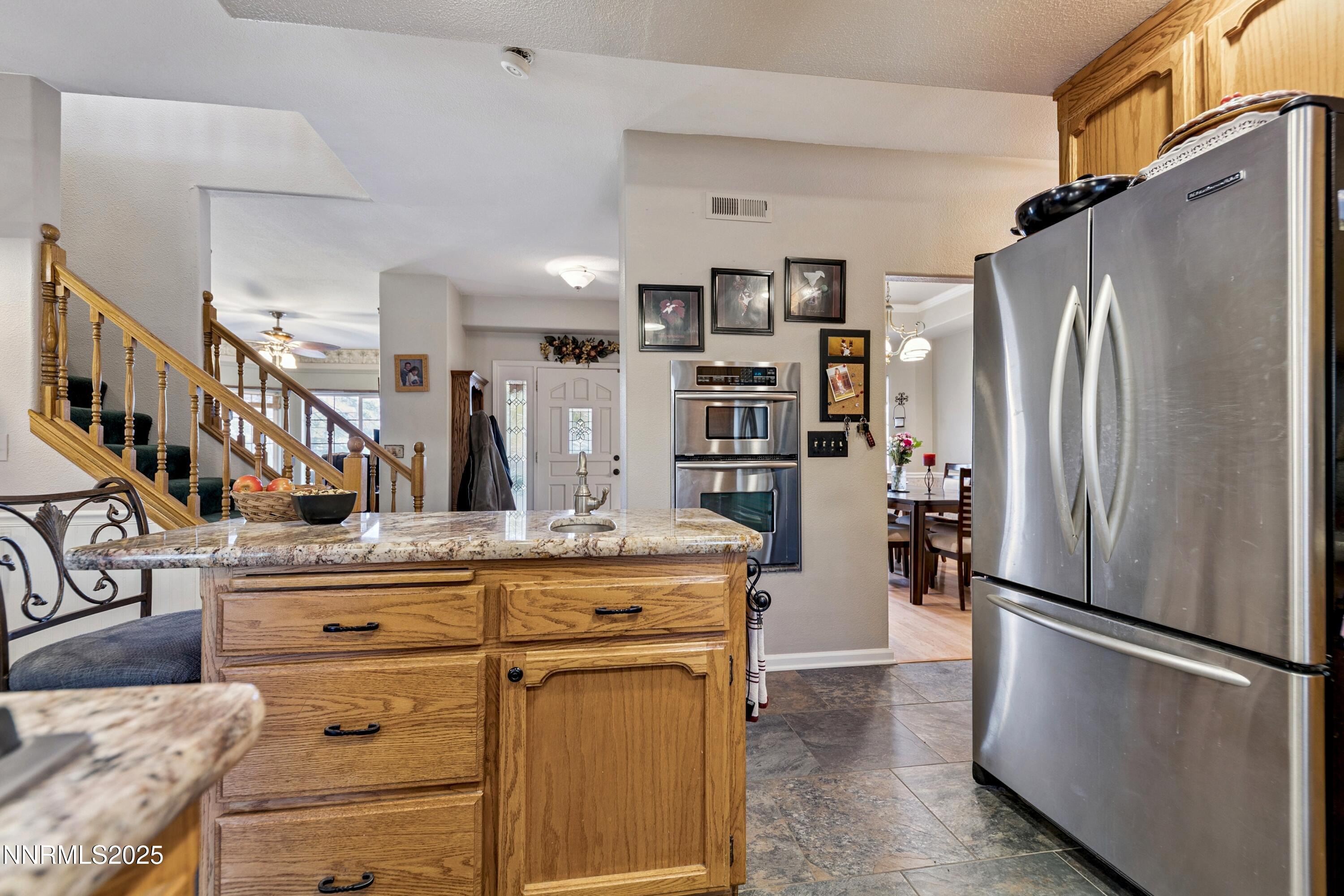955 Carol Way Fernley, NV 89408 - Photo 27 of 42 a kitchen with stainless steel appliances granite countertop a refrigerator and a stove