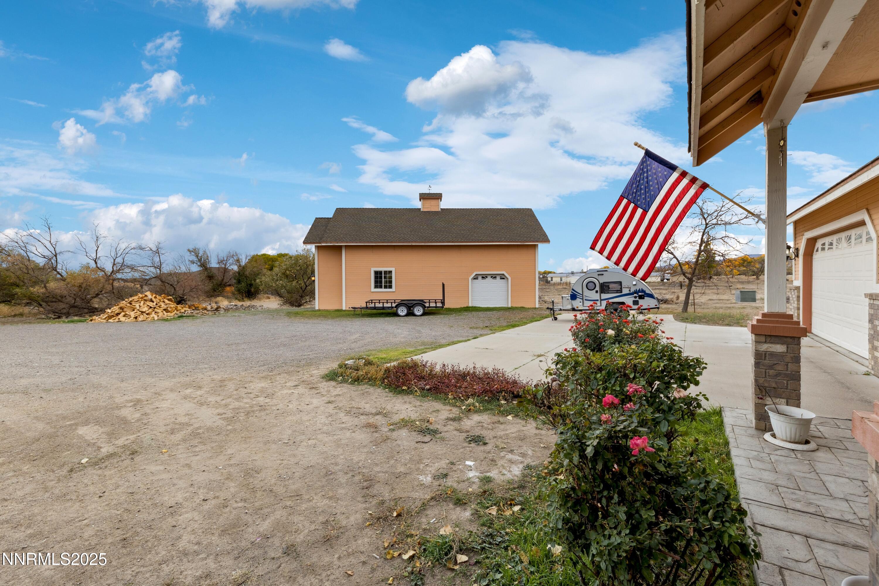 955 Carol Way Fernley, NV 89408 - Photo 42 of 42 a front view of a house with a yard and fountain in middle