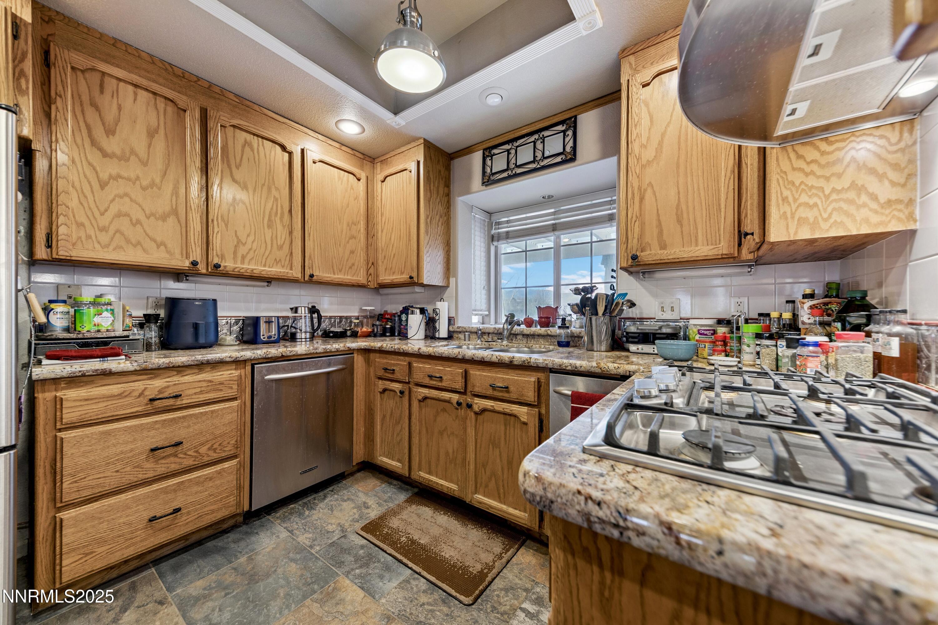 955 Carol Way Fernley, NV 89408 - Photo 5 of 42 a kitchen with stainless steel appliances granite countertop a stove a sink and a refrigerator