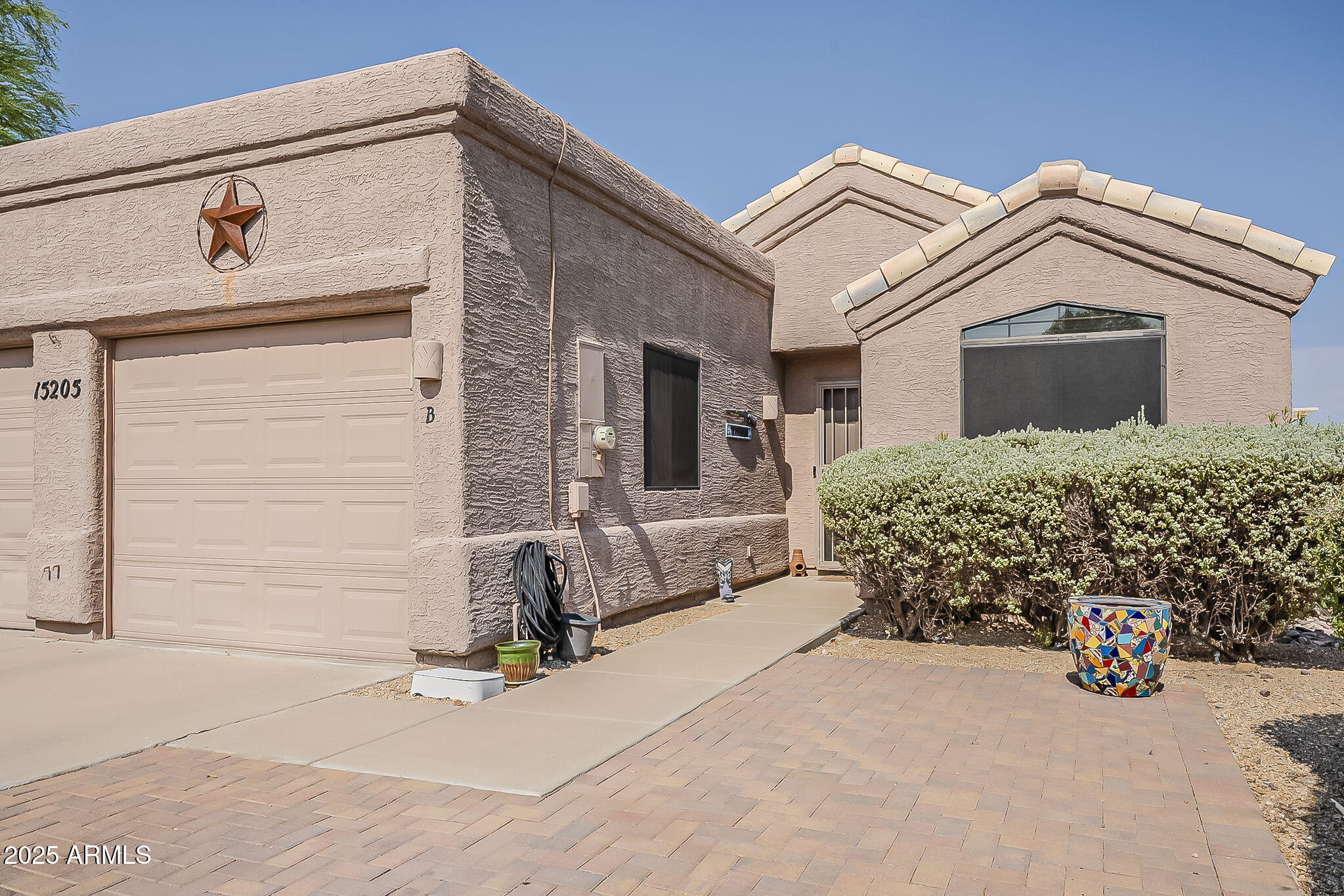 15205 North Ivory Drive, Unit B Fountain Hills, AZ 85268 - Photo 4 of 41 a view of a house with large windows and garage