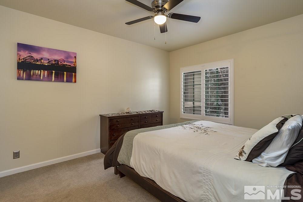 900 South, Unit 1424 Reno, NV 89521 - Photo 12 of 24 a bedroom with a bed and a chandelier