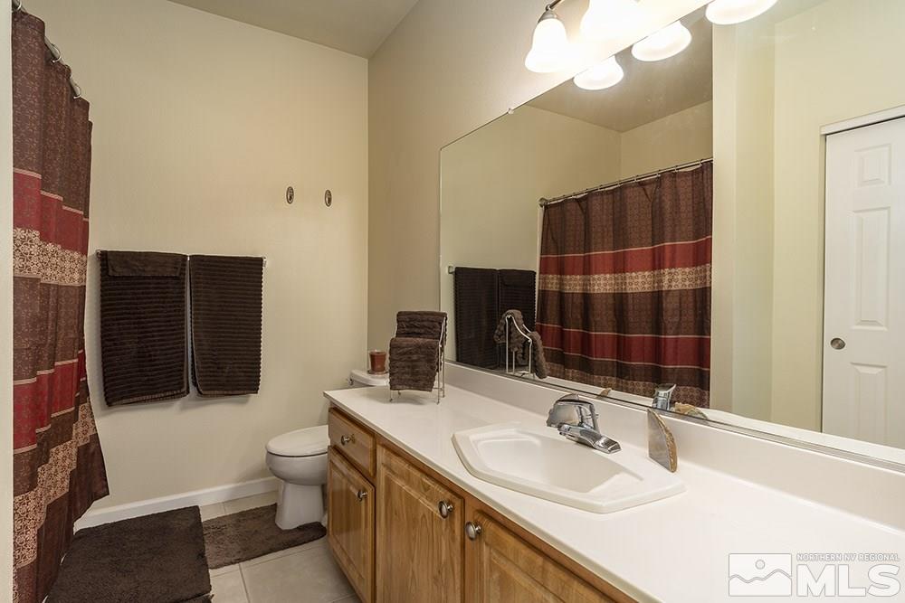 900 South, Unit 1424 Reno, NV 89521 - Photo 13 of 24 a bathroom with a sink and a mirror