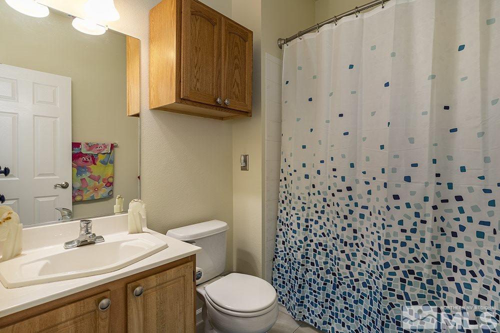 900 South, Unit 1424 Reno, NV 89521 - Photo 14 of 24 a bathroom with a sink toilet and shower