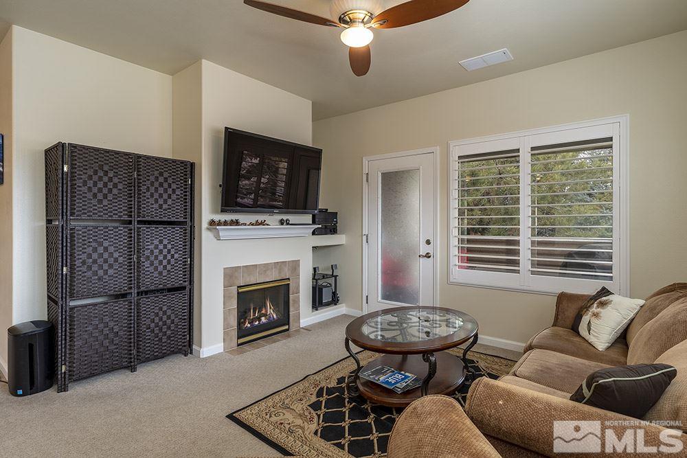 900 South, Unit 1424 Reno, NV 89521 - Photo 3 of 24 a living room with furniture a flat screen tv and a fireplace