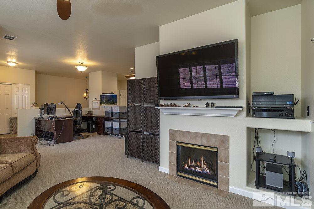 900 South, Unit 1424 Reno, NV 89521 - Photo 5 of 24 a living room with furniture a fireplace and kitchen view