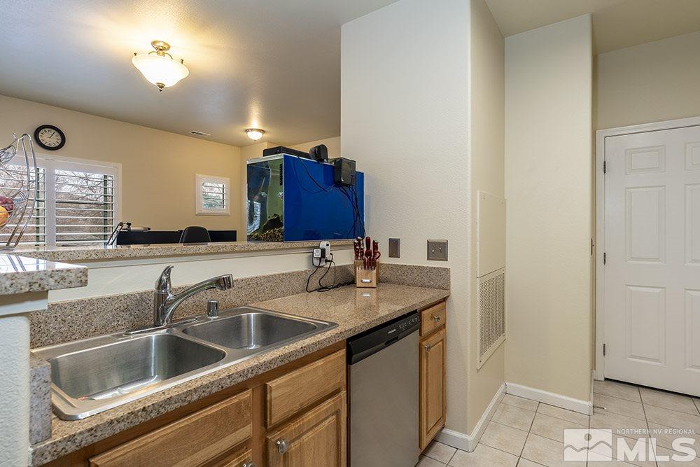 900 South, Unit 1424 Reno, NV 89521 - Photo 9 of 24 a kitchen with a sink and a refrigerator