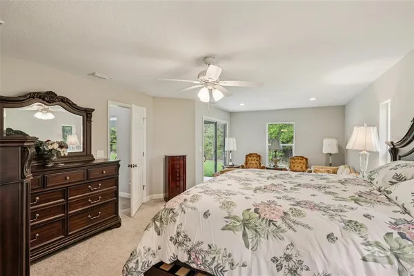 a bedroom with a bed and a flat tv screen on dresser