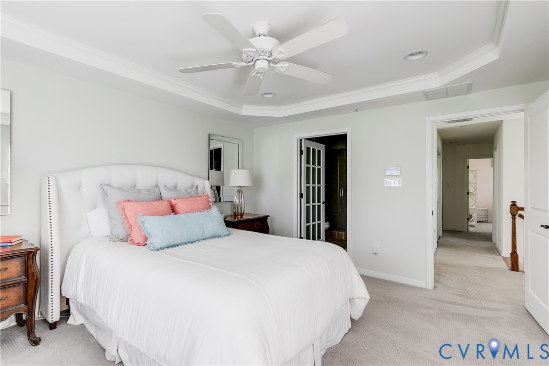 3900 Redbud Road Glen Allen, VA 23060 - Photo 23 of 37 a bedroom with a large bed and a chandelier