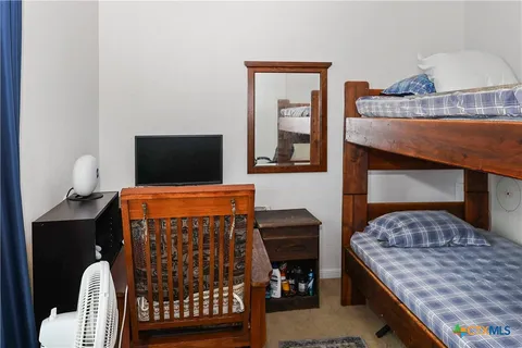 a bedroom with a bed and a television