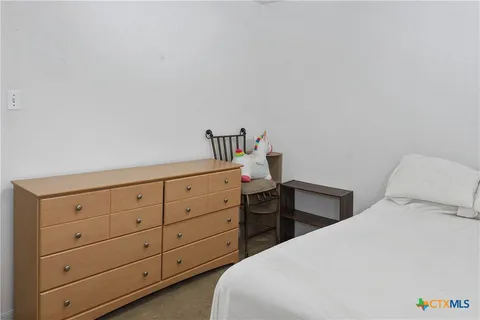 a bedroom with a bed and a dresser