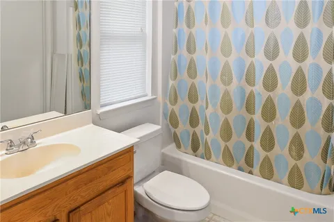 a white toilet sitting next to a bathroom sink