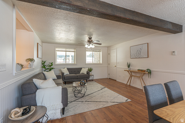 1045 Fox Farm Road Logan, UT 84321 - Photo 26 of 65 Living area featuring a textured ceiling, wainscoting, wood finished floors, and ceiling fan