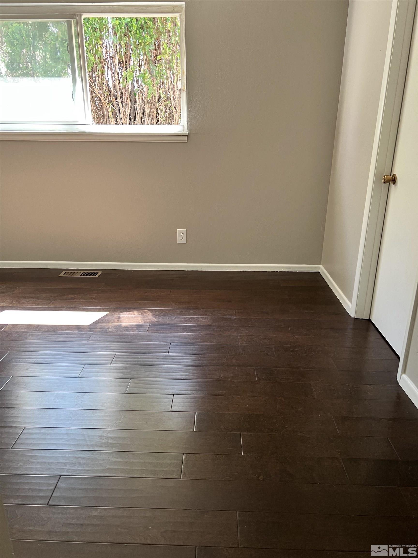 908 Lester Avenue Reno, NV 89502 - Photo 11 of 35 a view of a room with wooden floor and window