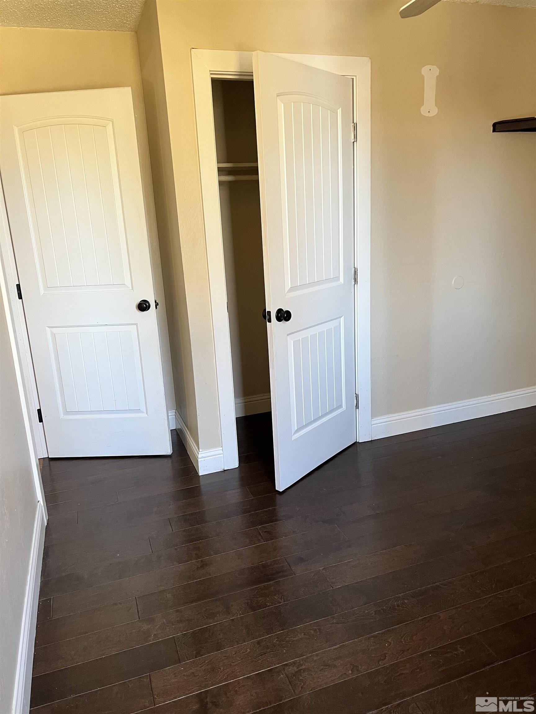 908 Lester Avenue Reno, NV 89502 - Photo 12 of 35 an empty room with wooden floor and closet