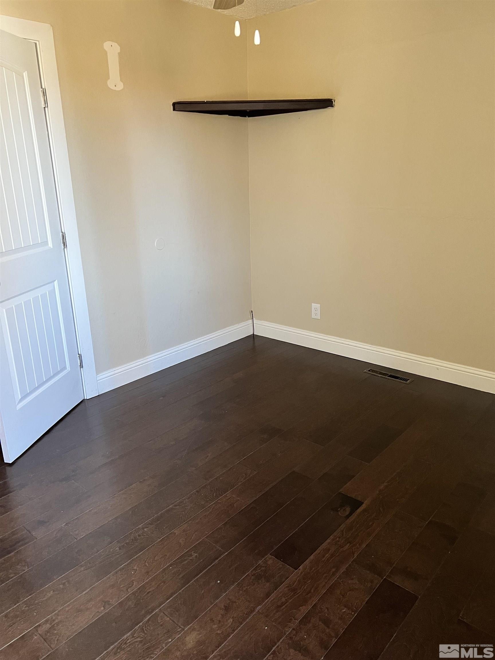 908 Lester Avenue Reno, NV 89502 - Photo 13 of 35 a view of an empty room with wooden floor and a window